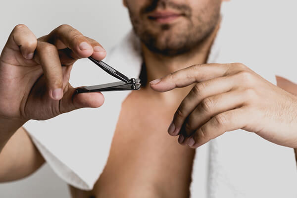 man cutting nails