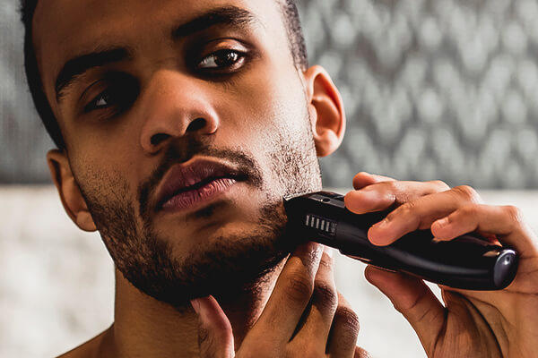 man using electric razor